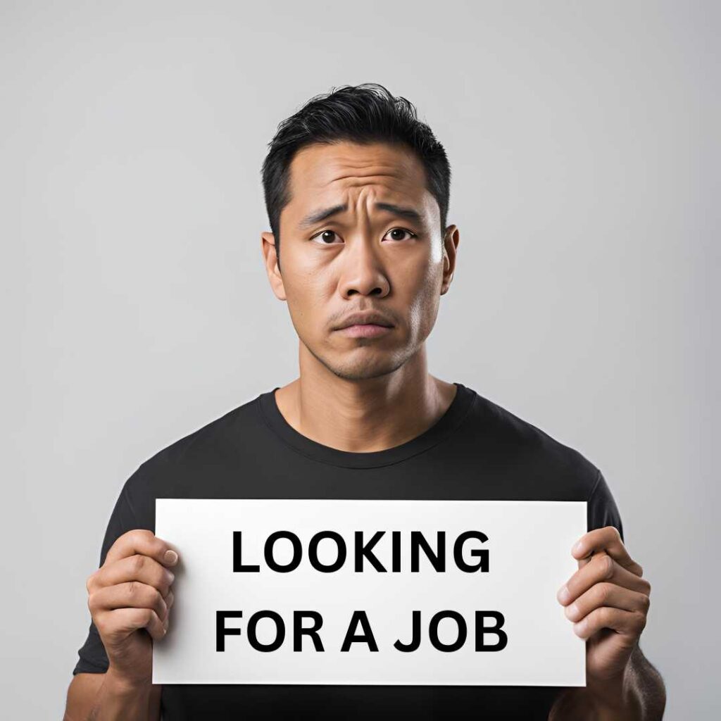 man holding up a sign with the words "Looking for a job"
